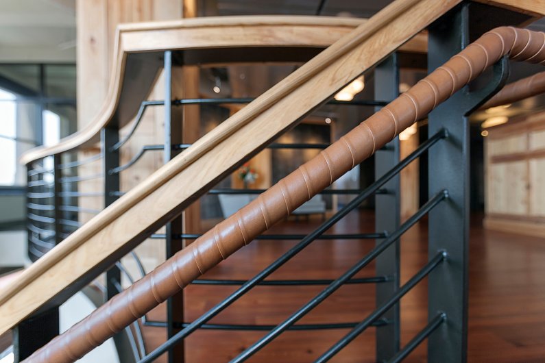 Overlap wrap handrail in brown leather at Greystar